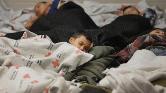 children sleeping in a holding cell